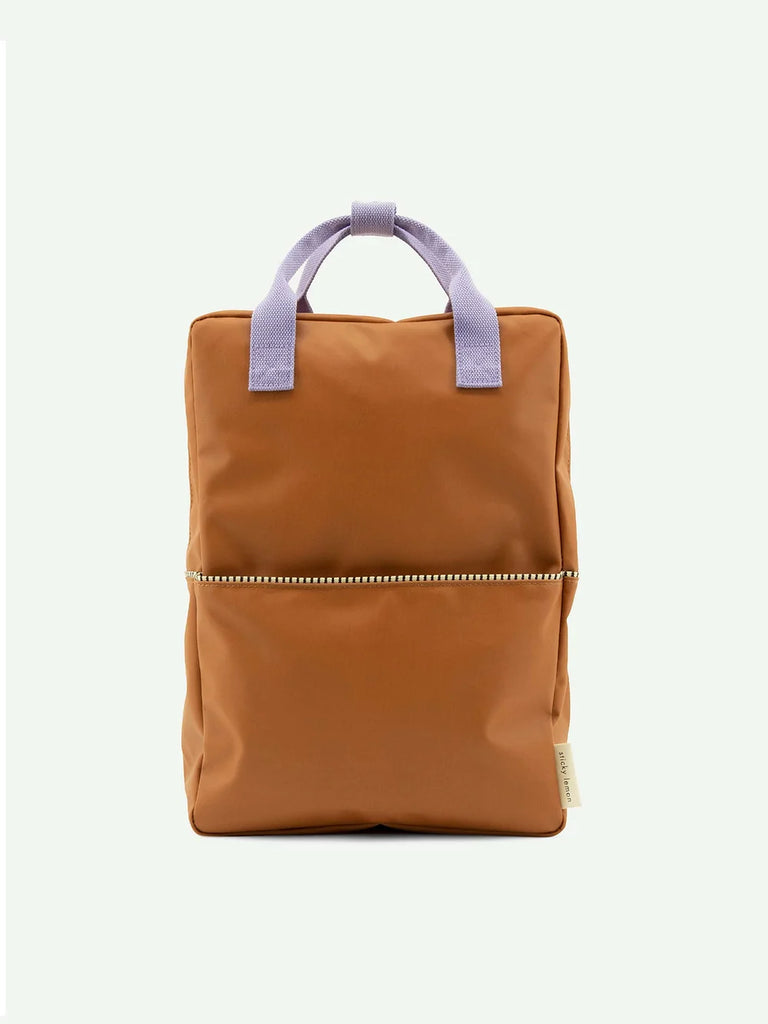 A Sticky Lemon Backpack | Uni | Buddy Brown with a front YKK zipper pocket and purple handles against a plain white background.