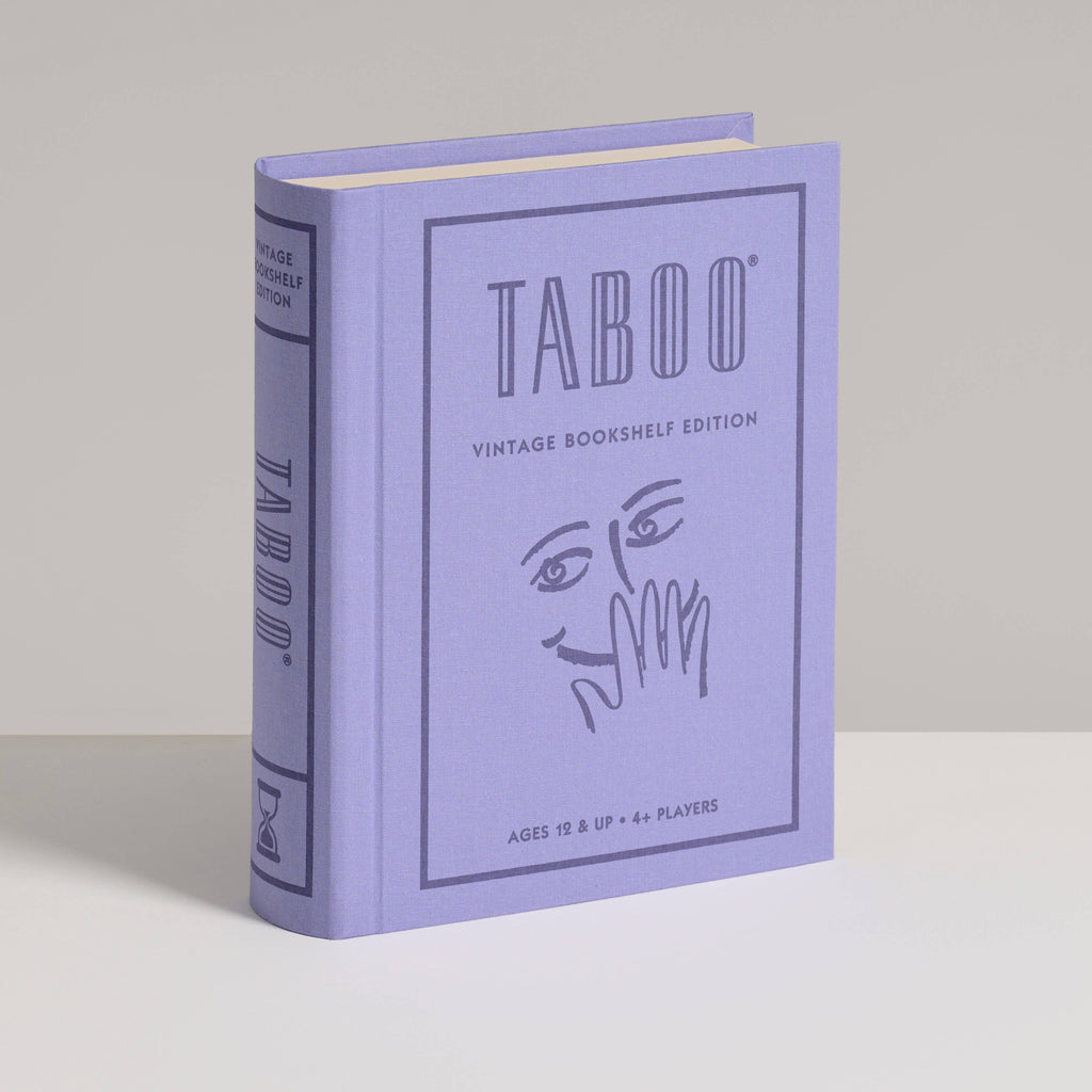 A lavender "Board Game: Taboo Vintage Bookshelf Edition" stands upright, its cover showing a cartoon face with a hand over its mouth. Suited for ages 12+ and 4+ players, it captures the classic word game’s playful spirit.