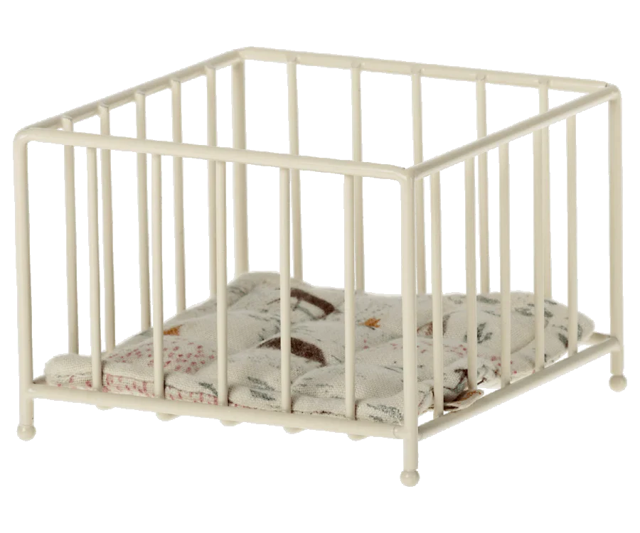 The Maileg Playpen Micro is a small white metal playpen with vertical bars and a soft patterned cushion, ideal for Maileg friends to enjoy cozy naptime in dolls' or miniature settings.