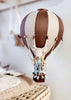 The Hot Air Balloon - Light Brown / Dark Brown features a small stuffed mouse in overalls sitting in a basket, making a charming indoor decoration for children's rooms.