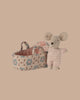 PRE-ORDER: Baby Mouse in Carry Cot - Rose. This tiny mouse wears a knitted suit and comes with a soft, patterned carry cot featuring rose designs and a handle. Estimated ship date is late October.