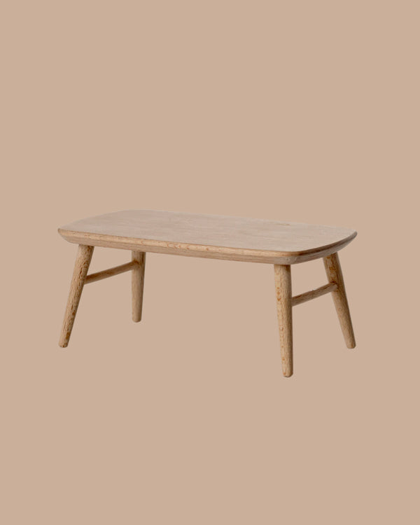 The PRE-ORDER: Coffee Table, Mouse - Nature features a small rectangular wooden design with rounded edges and four angled legs, perfect for cosy gatherings. Estimated ship date: Early October. Set against a plain beige background.