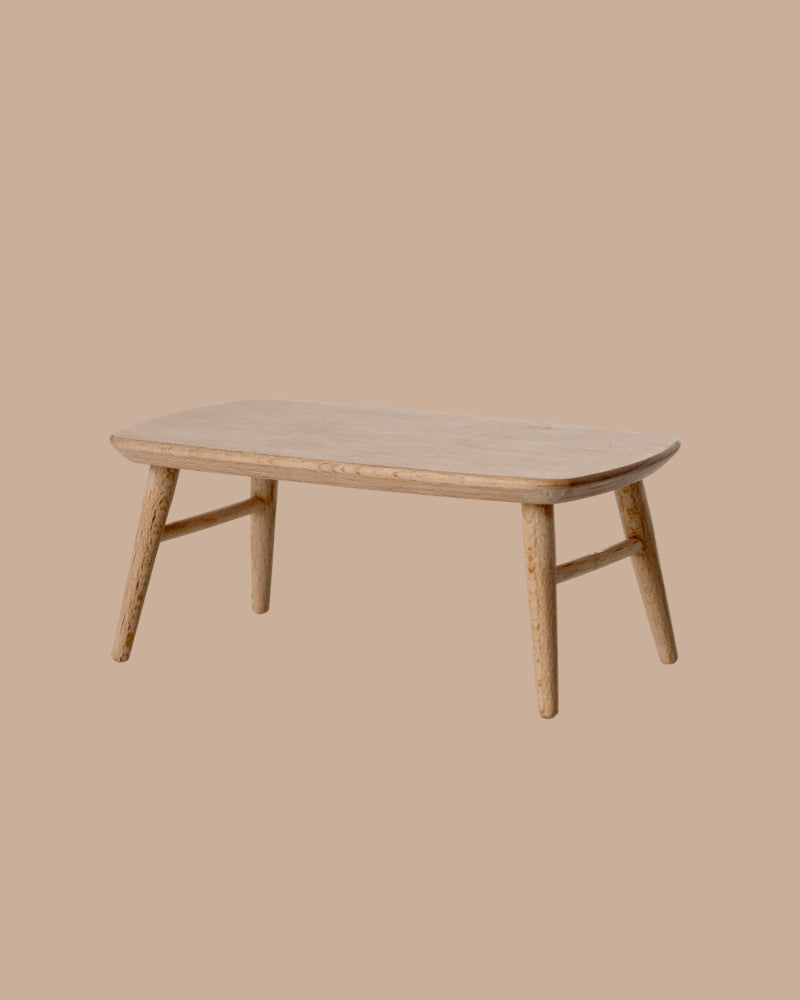 The PRE-ORDER: Coffee Table, Mouse - Nature features a small rectangular wooden design with rounded edges and four angled legs, perfect for cosy gatherings. Estimated ship date: Early October. Set against a plain beige background.