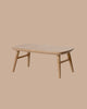 The PRE-ORDER: Coffee Table, Mouse - Nature features a small rectangular wooden design with rounded edges and four angled legs, perfect for cosy gatherings. Estimated ship date: Early October. Set against a plain beige background.