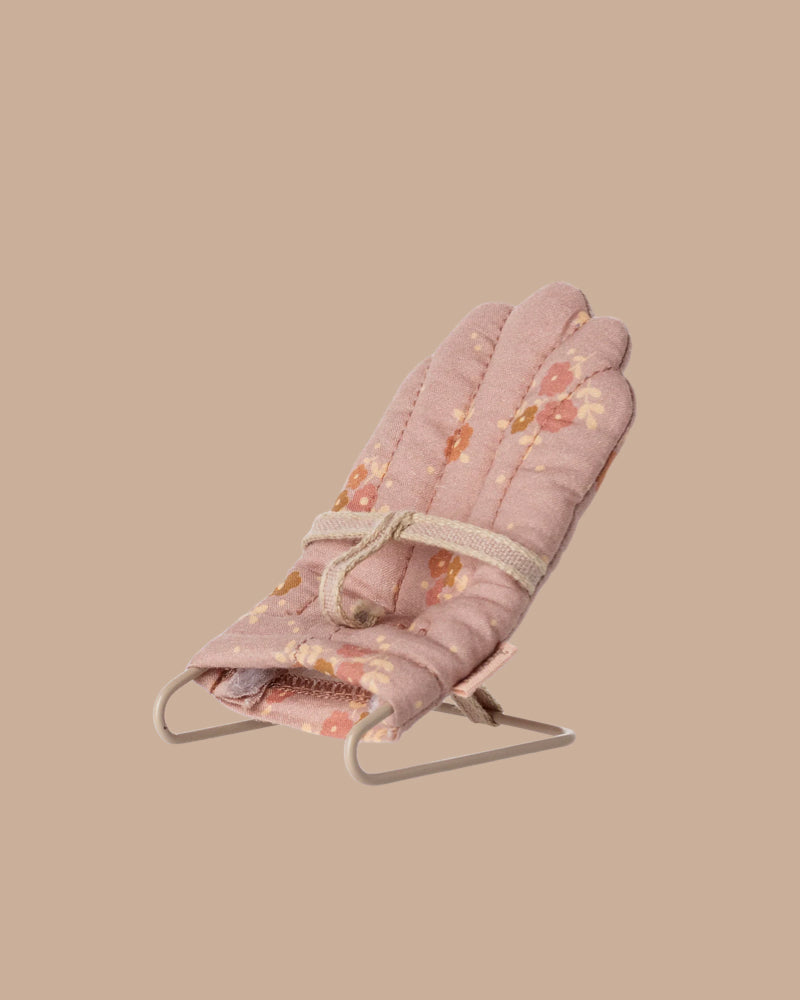 The PRE-ORDER: Babysitter, My - Rose is a small pink floral-patterned baby bouncer with sweet bunny designs, metal frame, and fabric safety strap. Estimated ship date: Late September. Set against a plain beige background.