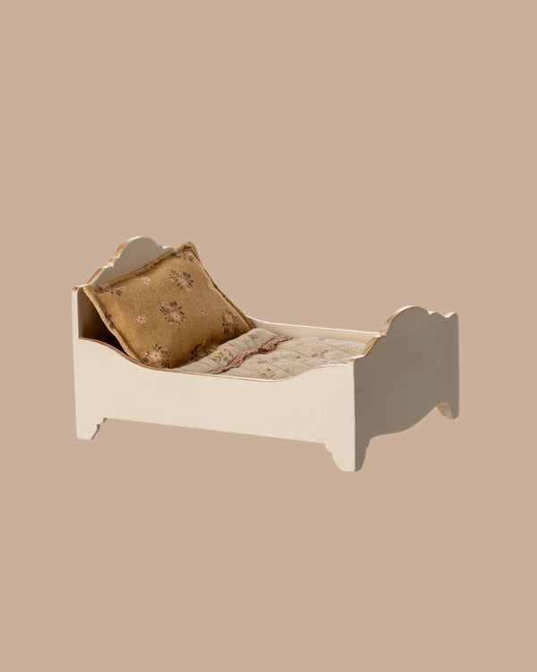 The PRE-ORDER: Bed, Mouse - Off White is a small white wooden bed with a floral-patterned mattress and gold pillow, ideal as a miniature mouse bed. Estimated ship date: Early October.