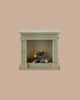 PRE-ORDER: Fireplace, Miniature – Dusty Green (ships early October), features a small rectangular shape with vintage finish and artificial logs; perfect for adding charm to any miniature home. Set against a plain beige background.