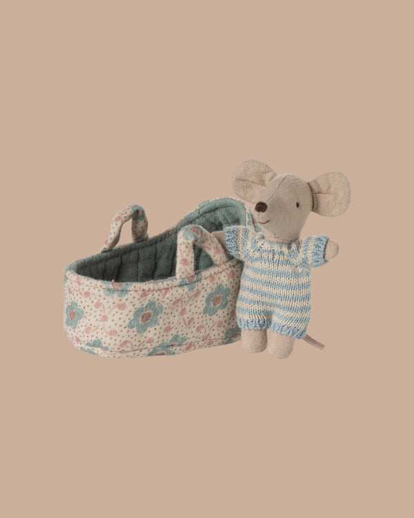 PRE-ORDER: Baby Mouse in Carry Cot - Blue (ships late October) features a tiny mouse in a blue and white knit suit beside a soft, floral-patterned quilted carry cot with two handles, shown against a plain beige background.