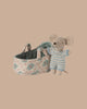 PRE-ORDER: Baby Mouse in Carry Cot - Blue (ships late October) features a tiny mouse in a blue and white knit suit beside a soft, floral-patterned quilted carry cot with two handles, shown against a plain beige background.