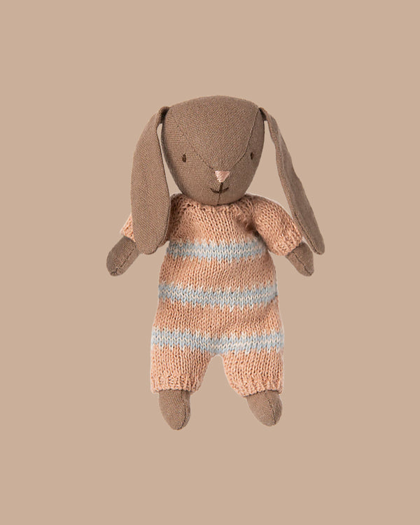 A soft Brown Micro Bunny in a dusty rose knitted suit is shown against a beige background, perfect for pairing with Maileg accessories or displaying in a miniature dollhouse. PRE-ORDER: Estimated ship date early October.