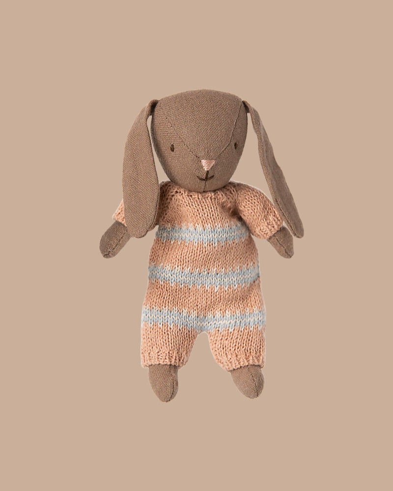 A soft Brown Micro Bunny in a dusty rose knitted suit is shown against a beige background, perfect for pairing with Maileg accessories or displaying in a miniature dollhouse. PRE-ORDER: Estimated ship date early October.
