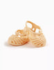 A pair of small peach Minikane Beach Sandals with woven straps and ankle closures for dolls, shown against a plain white background.