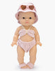 A Minikane doll models the Emile & Ida, Ursula 3-piece Swimsuit in terrycloth - Petal, featuring a matching bucket hat and heart-shaped sunglasses, standing upright against a white background.