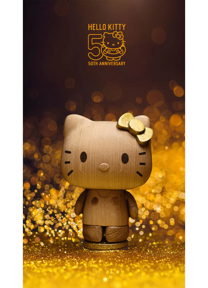 The Boyhood Hello Kitty 50th Anniversary Limited Edition figurine, featuring a golden bow, stands on a glittering gold base, with "Hello Kitty 50th Anniversary" and a gold logo displayed above against a dark background.