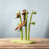 The Bumbu Handmade Wooden Red Panda Family with Bamboo Set features three small, smooth, handcrafted figures climbing and sitting on bamboo stalks—ideal as Montessori learning toys.