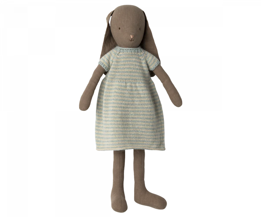 A Maileg Bunny Size 4, Brown - Knitted Dress made from natural linen fabric, wearing a green and white striped dress. The bunny has long ears, round black eyes, and an embroidered pink nose. The short-sleeved dress fits snugly on the bunny, making it suitable for all ages.