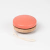 A red painted Wooden Yoyo made of beech wood with a white string, placed on a plain white background.