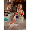 Kid sitting on world shaped pouf