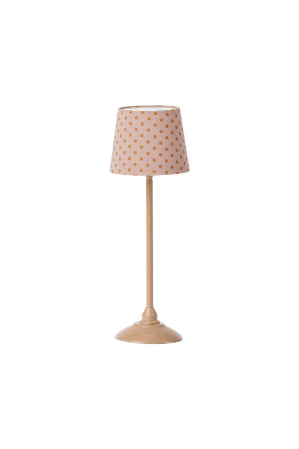 The Maileg Nursery Set includes a charming beige table lamp with a round base and tall, slender stand. Perfect for cozy spaces, its lampshade has small brown polka dots on a white background, making it an ideal addition to any room loved by Maileg fans or mouse families in doll houses.