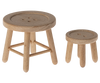 Part of the Maileg Living Room Set, two wooden stools resembling buttons, one larger than the other, accompany a Maileg Floor Lamp. The stools feature round seats with button impressions and three legs in natural wood finish against a white background.