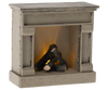 The charming Maileg Dining Starter Set includes a quaint rustic wooden model fireplace with logs and a warm, glowing light effect. It complements any Maileg set but watch out for small parts that might pose a choking hazard.
