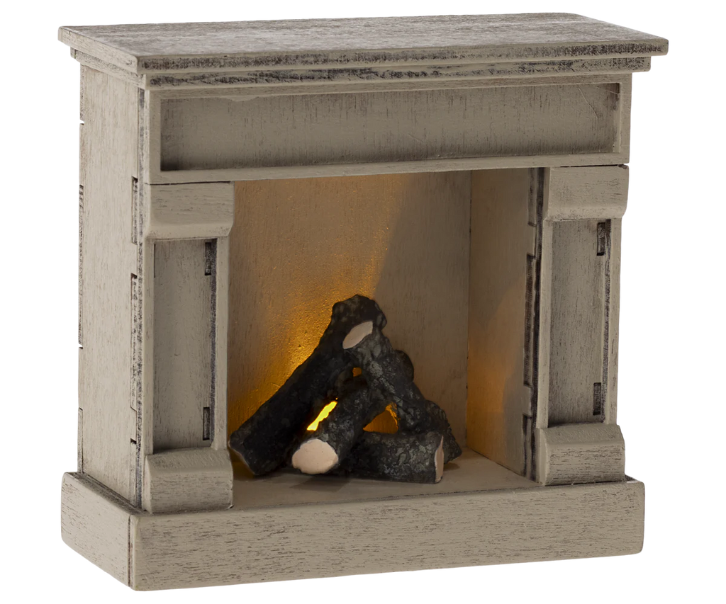 The charming Maileg Dining Starter Set includes a quaint rustic wooden model fireplace with logs and a warm, glowing light effect. It complements any Maileg set but watch out for small parts that might pose a choking hazard.