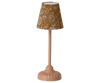 A beige, vintage-style table lamp features a floral-patterned fabric shade and a rounded base, gracefully reminiscent of Maileg floor lamps from the Maileg Living Room Set.