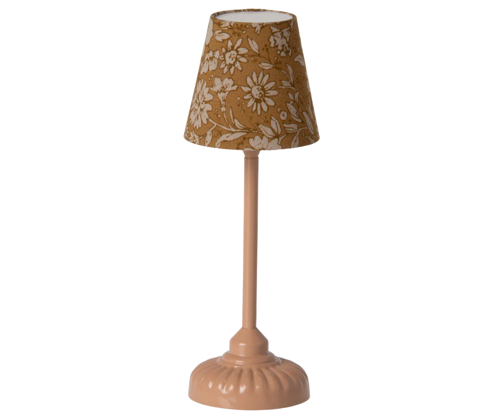 A beige, vintage-style table lamp features a floral-patterned fabric shade and a rounded base, gracefully reminiscent of Maileg floor lamps from the Maileg Living Room Set.