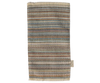 A multi-colored kitchen towel with horizontal stripes in blue, red, green, orange, and beige complements any kitchen featuring Maileg Living Room Set designs. The woven towel has a textured look, fringed edges, and a small side label.