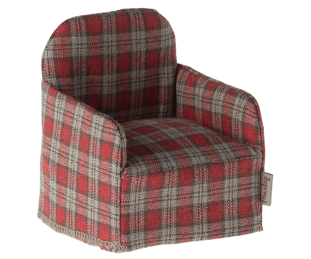 The Maileg Chair, Mouse - Red Checker is a miniature armchair featuring a red checker fabric pattern, ideal for small Maileg friends. Its squared back and cushioned seat make it perfect for dollhouse settings and cozy enough to fit inside the charming Maileg Gingerbread House.