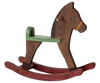 The Maileg Mouse Rocking Horse, available for shipping in a week, features a simple design with a brown body and green seat on red rockers. Its basic shape, peg tail, and minimalistic face invite children and imaginary mice to charming adventures in whimsical play scenes.