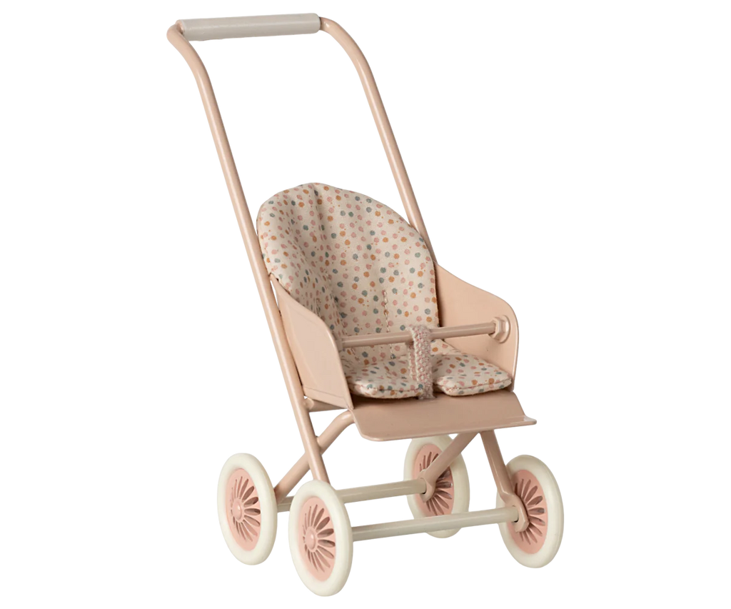 The Maileg Stroller, Micro - Powder features a light pink frame, white wheels, and a cushioned seat with colorful polka dot fabric.