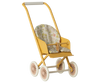 The Maileg Stroller, Micro - Yellow features white wheels and a floral-patterned seat, perfectly sized for dolls or stuffed animals.