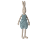 The Maileg Rabbit size 4 from the Bunny & Rabbit collection wears a knitted blue romper. Made of natural linen, it features a simple design with long ears, a soft beige color, and arms hanging by its sides while standing against a plain white background.