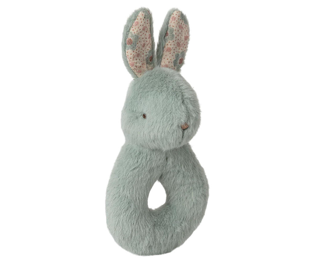 The Maileg Bunny Rattle Set in Mint features a soft, plush bunny made from gentle cotton with pale green fur. It includes long ears with a floral interior, a convenient grip hole, and a simple stitched face. Perfect for gifting as part of any nursery setup.