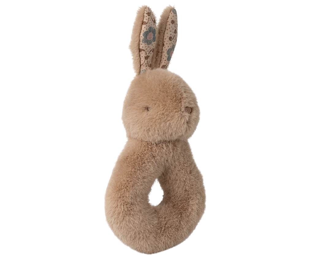 The Maileg Bunny Rattle Set - Cream Peach is a soft, plush beige ring-shaped rattle made of cotton. It features long ears with a floral inner pattern and stitched eyes and nose. Ideal for infants and toddlers, it comes in an elegant gift box.
