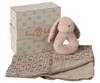 The Maileg Bunny Rattle Set - Powder is a charming gift featuring a plush bunny teether, a soft patterned baby blanket, and a delightful bunny rattle, all nestled in a decorative box with floral designs and the words "bunny baby," making it the perfect present for a little one.