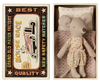 A Maileg Little Sister Mouse in fairy clothes rests in a matchbox bed with the lid reading "Grand Old Match Factory Best Quality Mouse Race New Safety Matches" and showcasing an illustration of a mouse racing a car.