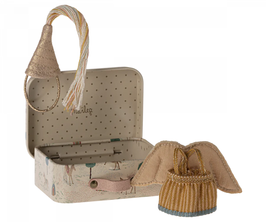 In an open, whimsical polka-dotted suitcase adorned with animals and trees, a Maileg Little Sister Mouse is nestled in its matchbox bed, donning a rope-style party hat. Nearby rests a fabric lion toy sporting a fringed mane.