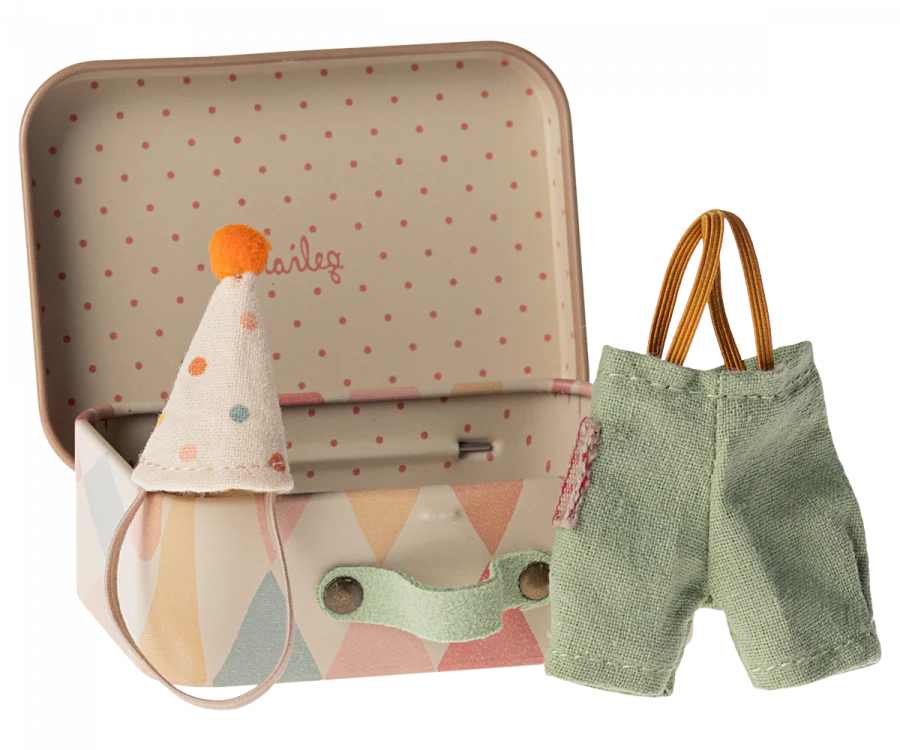 An open pastel suitcase with a polka dot interior holds tiny clothes, including a clown hat with pom-pom and green corduroy suspenders, tailored for Maileg items. Perfect for charming play like the "Maileg Little Brother Mouse With Extra Outfit & Suitcase.