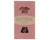 The "Maileg Skirt And Knitted Blouse For Mum Mouse" beautifully features a maroon skirt and a red-pink knitted blouse. Its packaging, set against a light pink background with a white arc pattern, adds an elegant touch to these charming garments. Ships in one week.