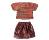 The Maileg Skirt and Knitted Blouse for Mum Mouse features a multicolored blouse and shiny pink skirt, perfect for your child's toy. Laid out flat on a plain background, this outfit will complete any adorable mouse clothes collection. Ships in one week.