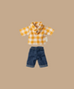 A beige backdrop highlights Maileg's Yellow Checked Shirt and Dark Blue Pants for Dad Mouse, featuring a charming pattern and a small side tag. Ships in one week.