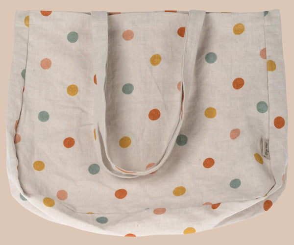 The Maileg Tote Bag With Multi Dots - Small is a beige linen fabric bag decorated with vibrant orange, yellow, red, and green polka dots. It has two sturdy handles and is shown flat against a plain background.