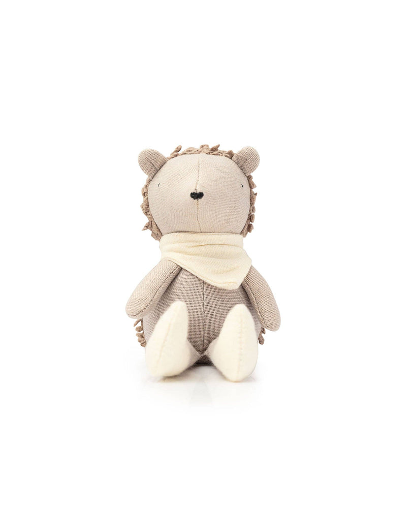 Poppet The Baby Hedgehog is a plush teddy resembling a baby hedgehog. It wears a cream scarf, is light brown with textured "spikes," and sits upright on a white background, making it an ideal pocket-sized garden companion.