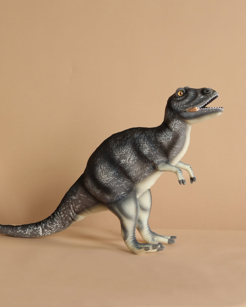 The Albertosaurus Dinosaur Stuffed Animal, with its realistic features, stands against a beige background. It showcases artisan craftsmanship with dark grey stripes and an open mouth displaying sharp teeth.