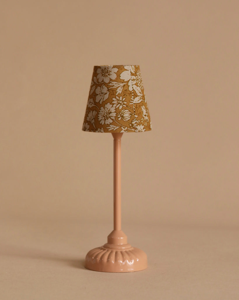The Maileg Moms Afternoon Tea Set features a small pink table lamp with a floral-patterned beige lampshade, perfectly sized for Mouse Paw Size decor and set against a plain beige background.