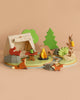 The Wildlife Camping Playset is a wooden toy set with a tent, campfire, table, trees, rocks, stream, and forest animals like a fox and owl—ideal for imaginative play or as an addition to any dolls house adventure.