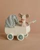 A Maileg Pram With Baby Mouse - Mint features a small stuffed mouse in a pink polka-dot outfit, seated inside a vintage-style white pram with mint and blue details, set against a beige background.