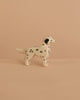 The Ostheimer Dalmatian Dog is a small, handcrafted wooden figurine with black spots, shown on a beige surface and matching background—ideal for imaginative play.